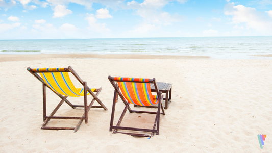 Two beach chairs sitting on a pristine beach